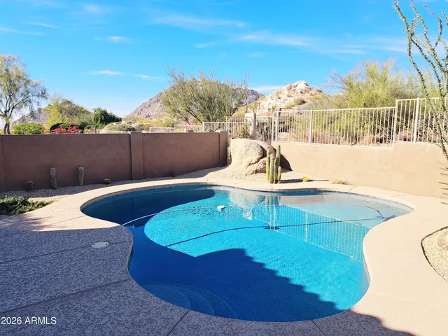 a view of an entrance with wooden floor and a building