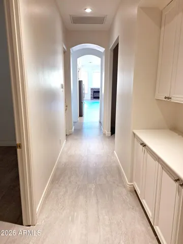 a view of a room with wooden floor and a window