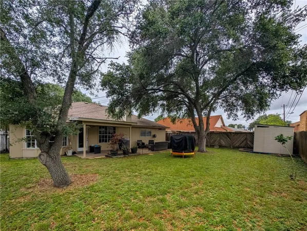 a view of a house with a yard and sitting area