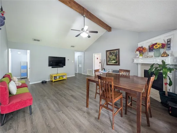 a view of a livingroom with furniture and a flat screen tv