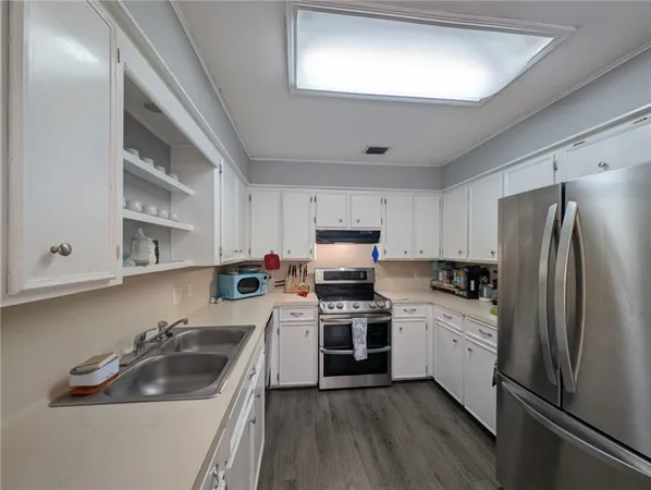 a kitchen with a sink cabinets and stainless steel appliances