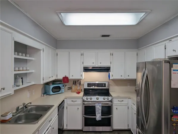a kitchen with a stove a sink and a refrigerator