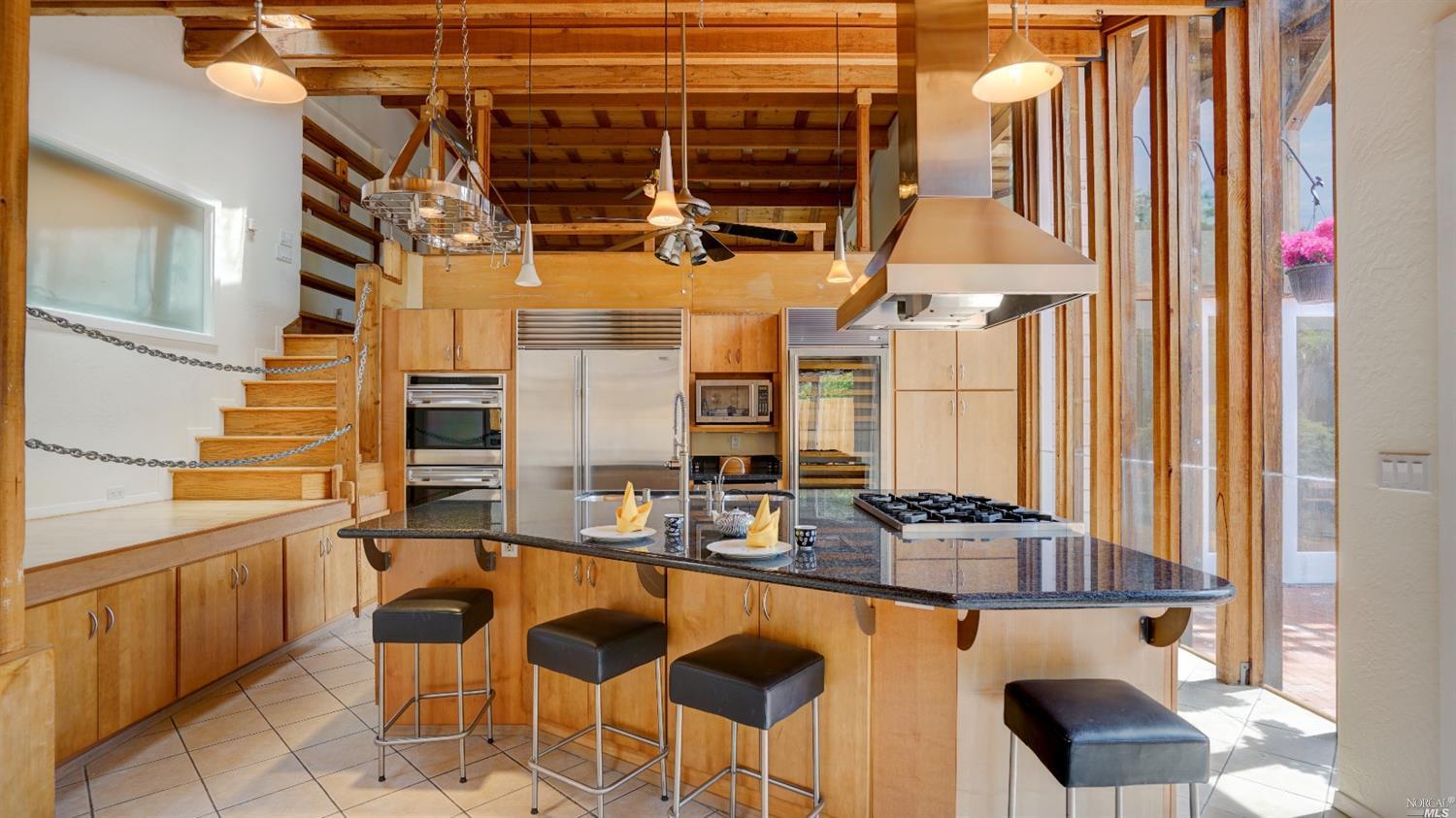 a balcony with chairs and table in the kitchen