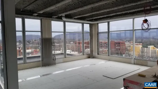 a living room with a large window with outer view