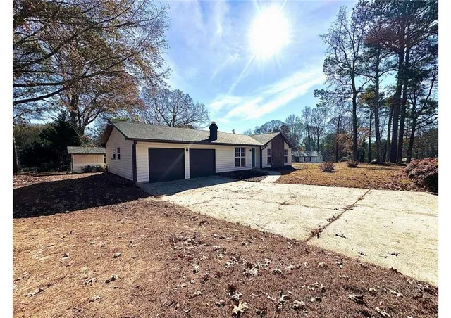 a front view of a house with a yard covered in snow