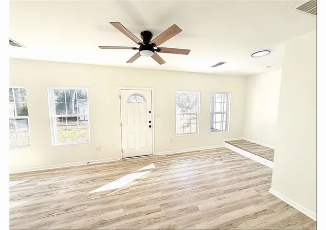 a view of a livingroom with a window and a ceiling fan
