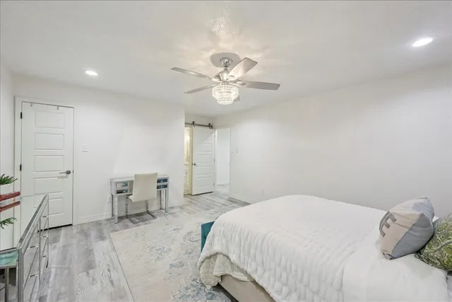 a bedroom with a bed and a chandelier