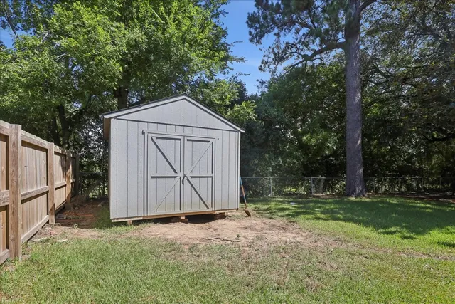 a front view of house with yard and trees