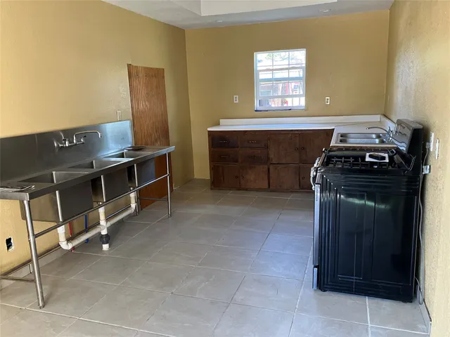 a kitchen with a stove and a sink