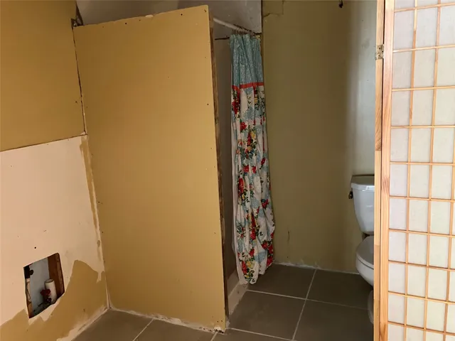 a bathroom with a shower and a sink