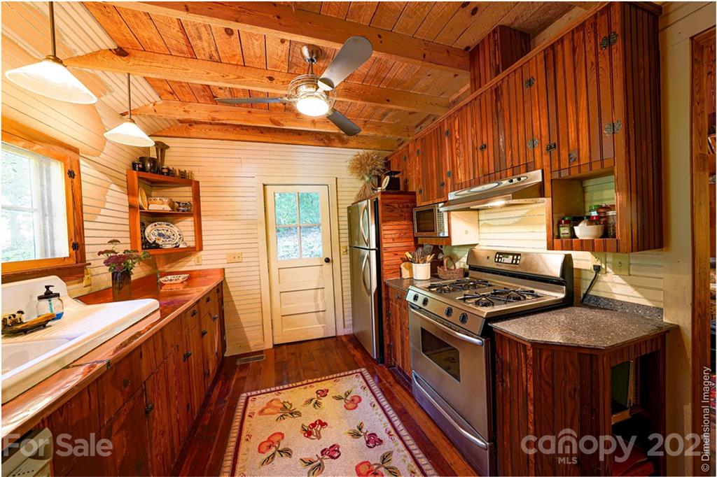 150 Staton Ridge Road Saluda, NC 28773 - Photo 3 of 44 a kitchen with stainless steel appliances a stove a sink and a refrigerator