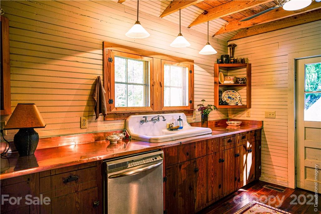 150 Staton Ridge Road Saluda, NC 28773 - Photo 7 of 44 a view of a kitchen with a sink and wooden cabinets