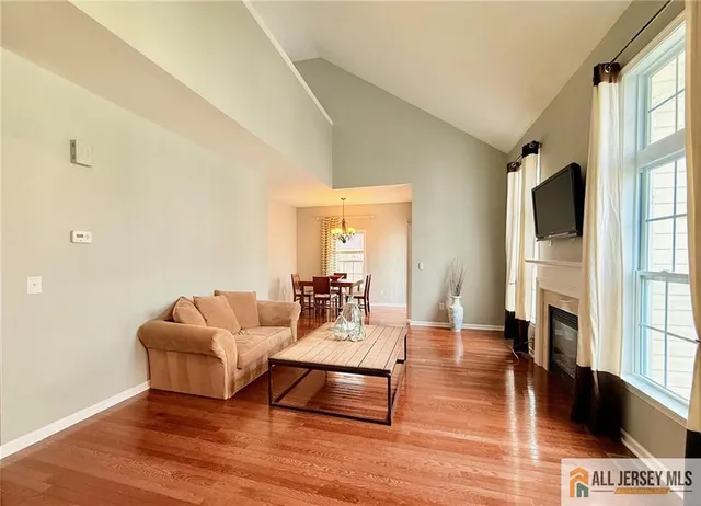 a living room with fireplace furniture and a flat screen tv