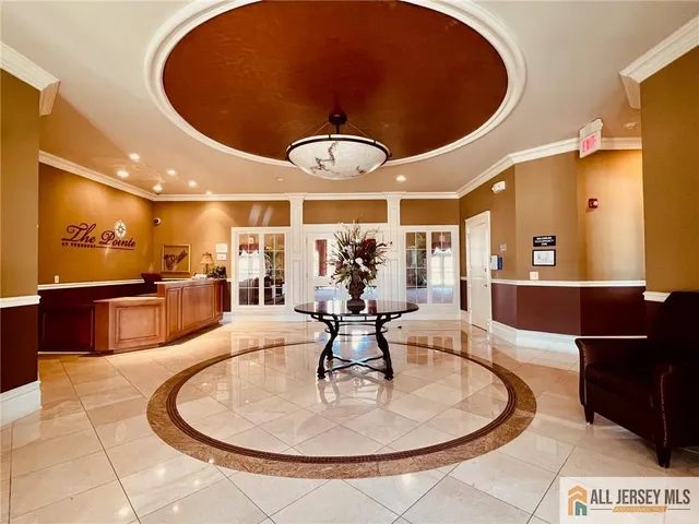 a lobby with a chandelier furniture and a large window