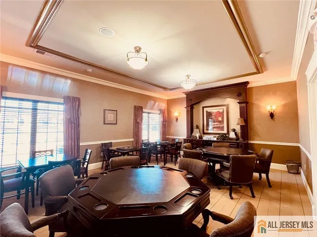 a living room with lots of furniture and a large window