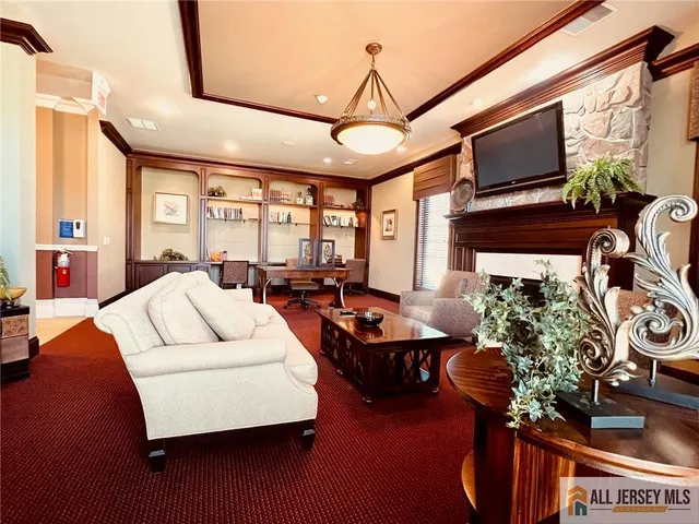 a living room with patio furniture and a flat screen tv