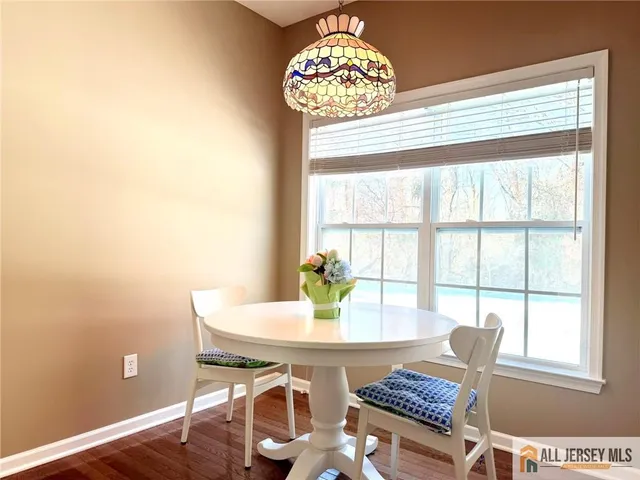 a dining room with furniture and window