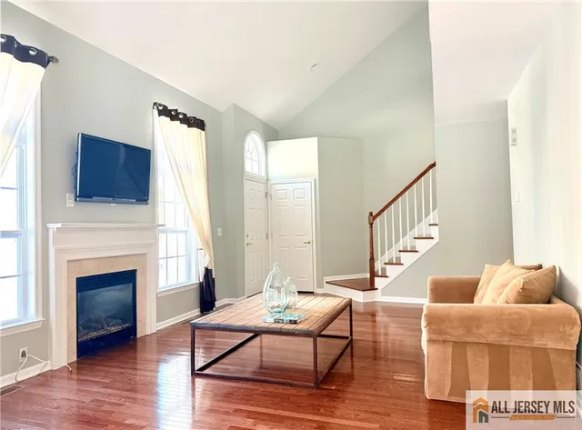 a living room with furniture fireplace and flat screen tv