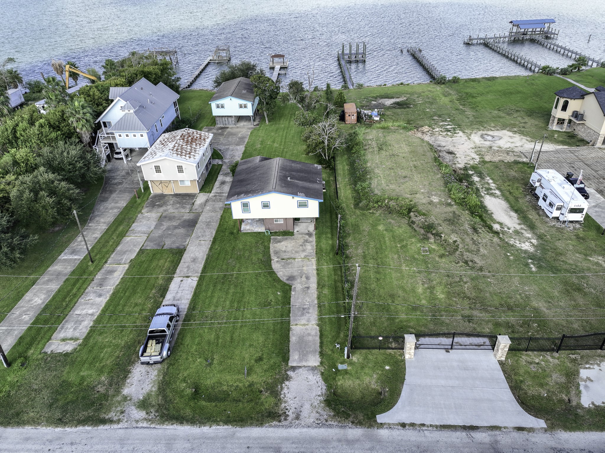 an aerial view of a house with garden space and street view