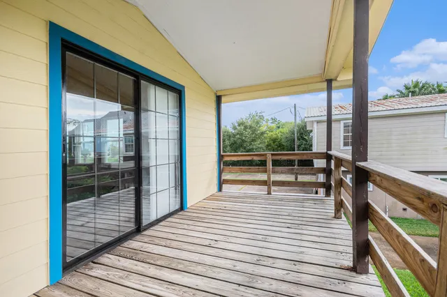 a view of a balcony with wooden floor
