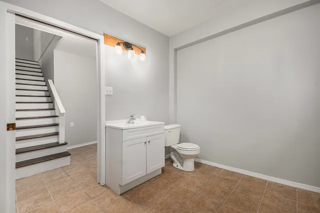 a bathroom with a sink toilet and vanity