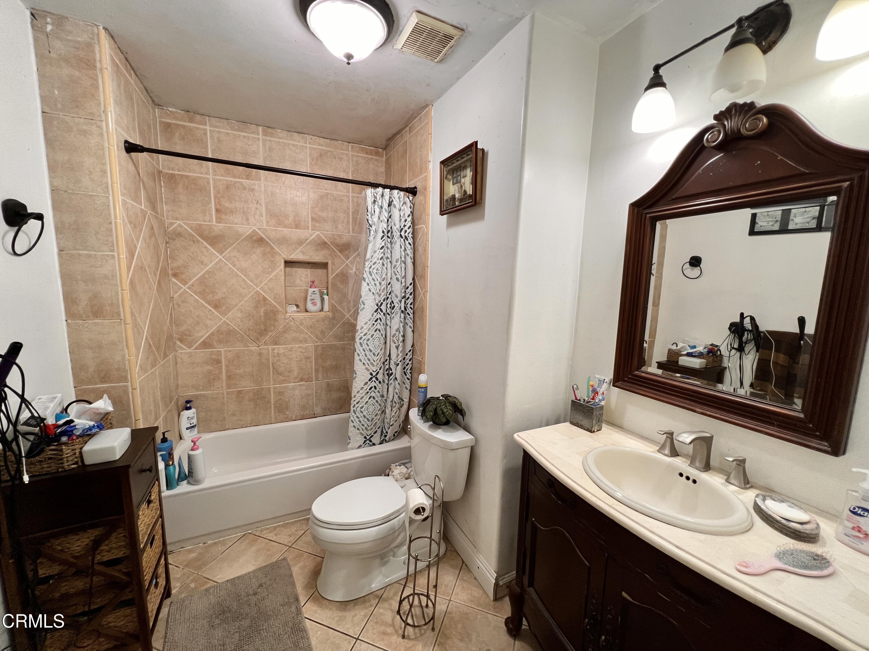 1017 King Street Oxnard, CA 93030 - Photo 14 of 22 a bathroom with a toilet a sink and a mirror
