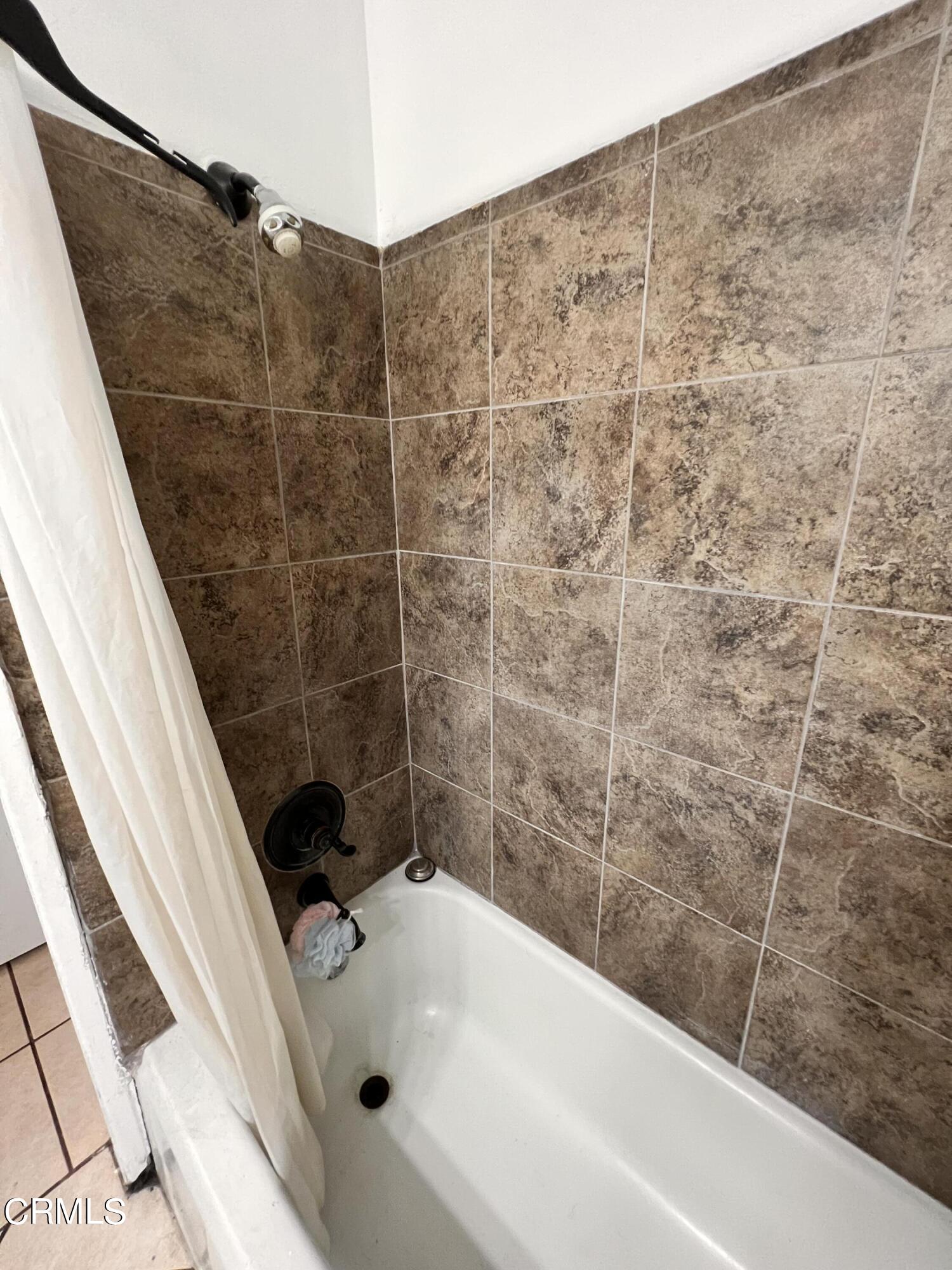 1017 King Street Oxnard, CA 93030 - Photo 16 of 22 a bathroom with a bathtub