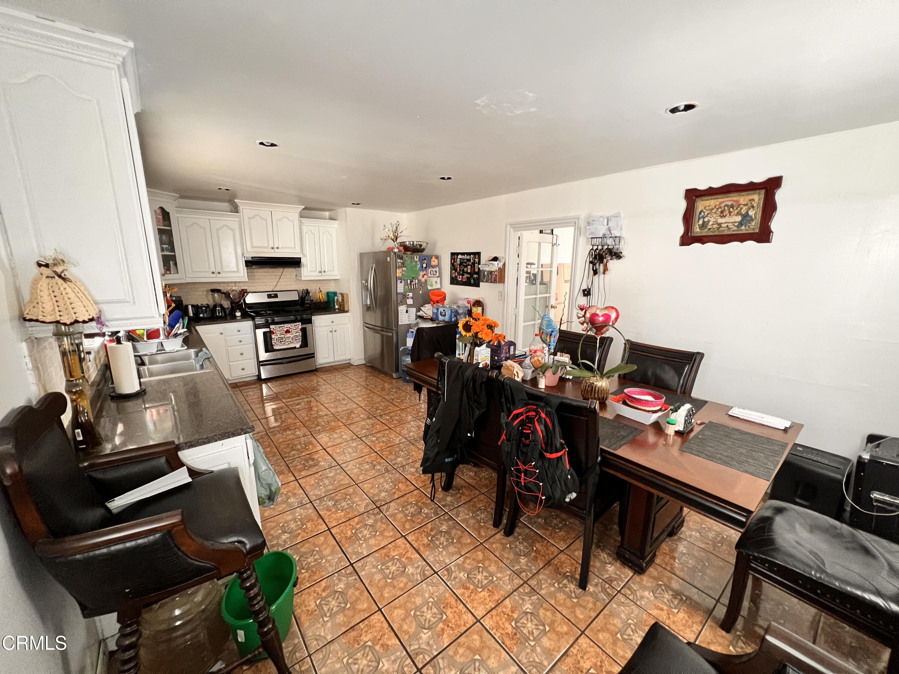 1017 King Street Oxnard, CA 93030 - Photo 7 of 22 a living room with lots of furniture and gym equipment