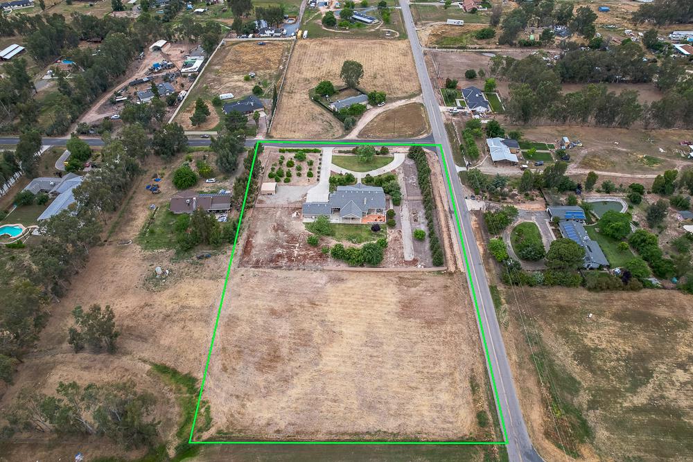 17465 Monreal Road Madera, CA 93636 - Photo 56 of 59 an aerial view of a house with a yard and greenery