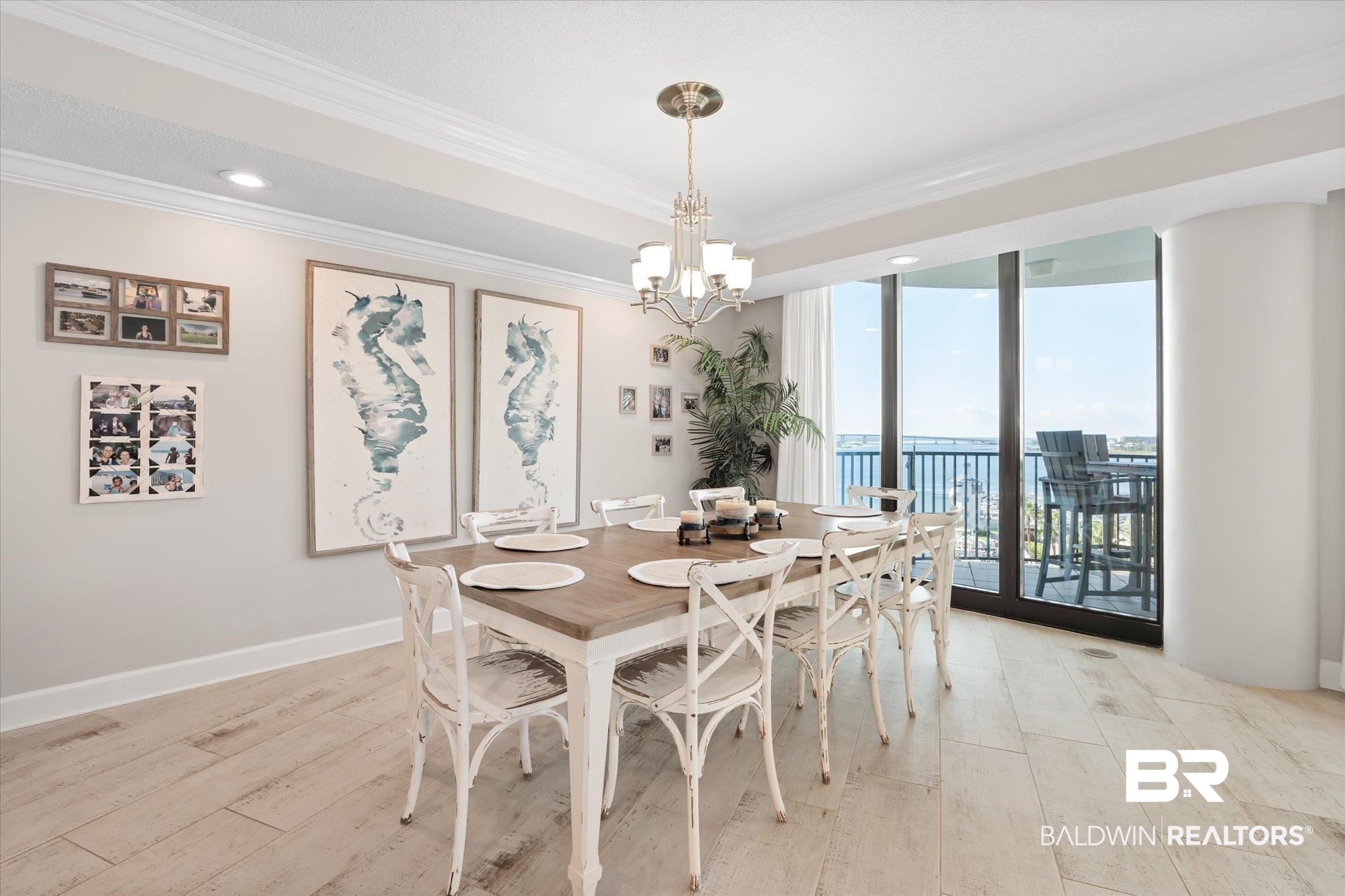 27582 Canal Road, Unit 2611 Orange Beach, AL 36561 - Photo 13 of 37 Dining area featuring ornamental molding, light wood-type flooring, a chandelier, and floor to ceiling windows