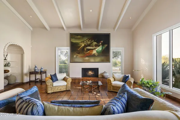 a view of a hall way with living room and a large window