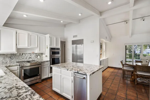 a kitchen with a stove and a refrigerator