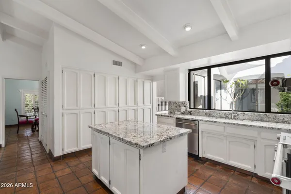 a view of a dining room with furniture and a window