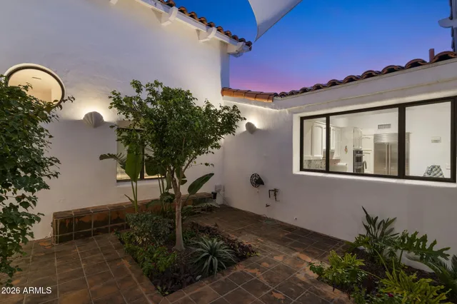 a living room with furniture and a book shelf