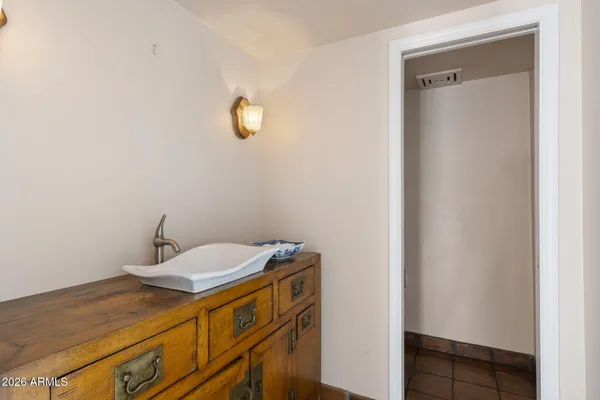 a bedroom with a large bed and a flat screen tv