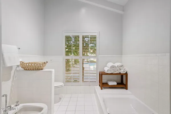 a bathroom with a double vanity sink mirror and shower