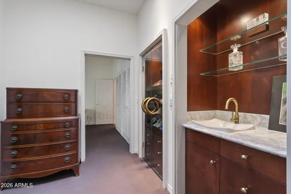 a bed sitting in a spacious bedroom next to a window