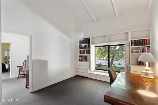 a view of an empty room with a fireplace and a large window