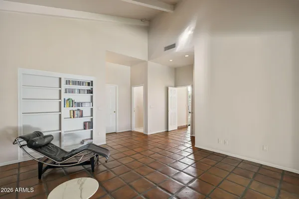 a view of a big room with windows and entryway