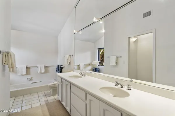 a view of a house with backyard sitting area and garden