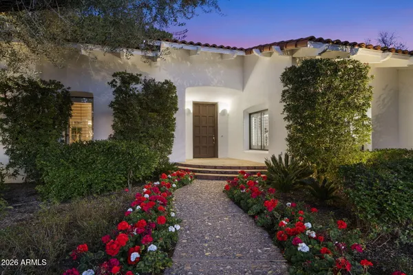 a view of a house with a flower garden