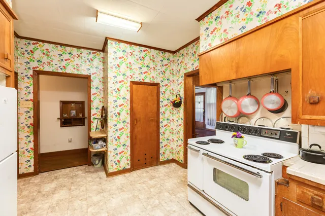 a kitchen with stainless steel appliances granite countertop a stove and a refrigerator