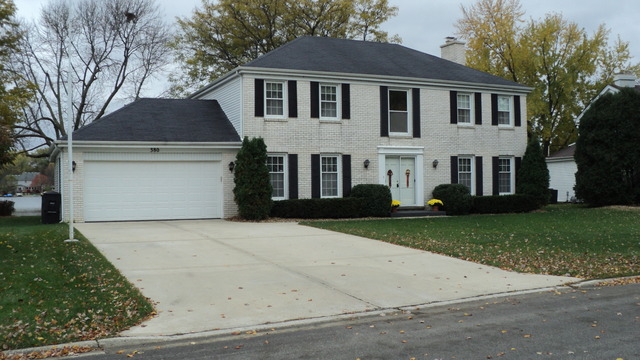 380 Northgate Road Lindenhurst, IL 60046 - Photo 2 of 19 a front view of a house with a yard and garage