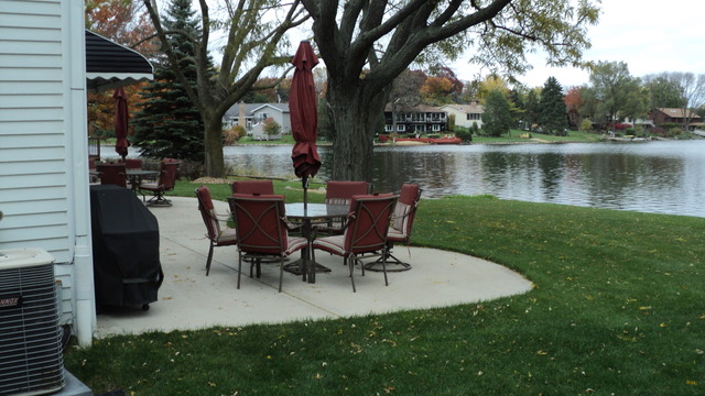 380 Northgate Road Lindenhurst, IL 60046 - Photo 18 of 19 a view of a lake with a table and chairs