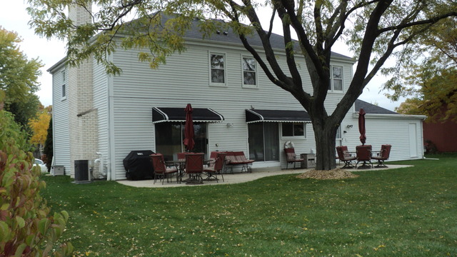 380 Northgate Road Lindenhurst, IL 60046 - Photo 3 of 19 a front view of house with yard and outdoor seating