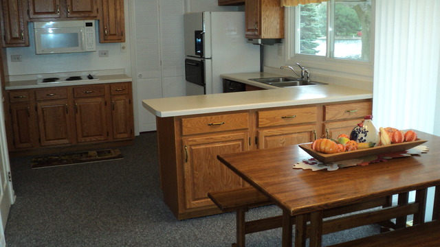 380 Northgate Road Lindenhurst, IL 60046 - Photo 6 of 19 a kitchen with a table chairs and a stove