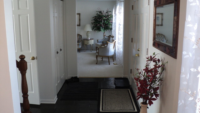 380 Northgate Road Lindenhurst, IL 60046 - Photo 8 of 19 a view of a hallway with wooden floor and a living room