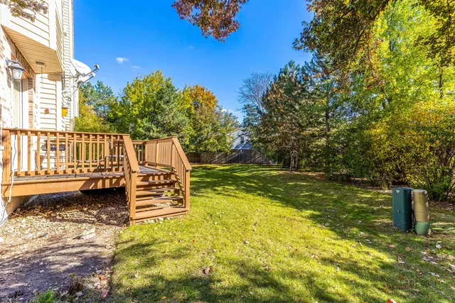 a view of a garden with wooden fence