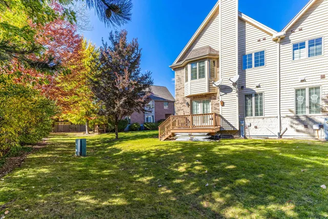 a view of a house with a yard and sitting area