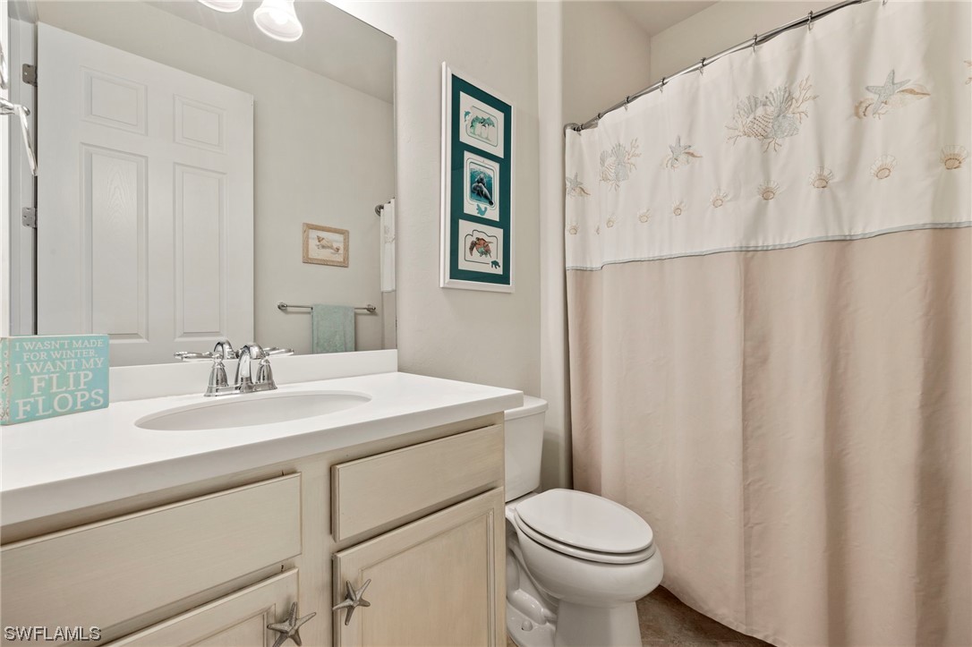 10844 Dennington Road Fort Myers, FL 33913 - Photo 20 of 50 a bathroom with a sink toilet and a mirror